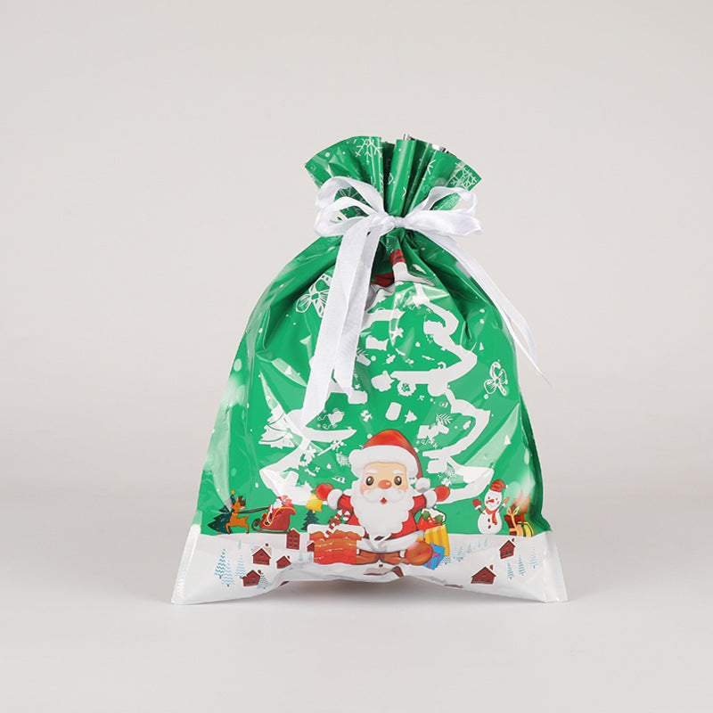 Green Christmas-themed gift bag with Santa Claus on a light gray background