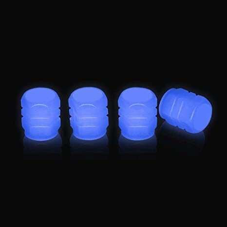 Set of four neon blue photoluminescent tire valve caps on black background