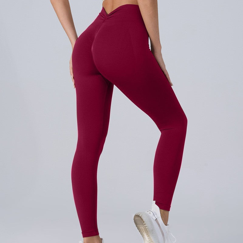 Maroon leggings worn by a person on a light gray background