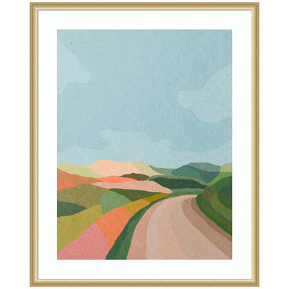 Winding country road leading through open landscape scenery in a wood frame