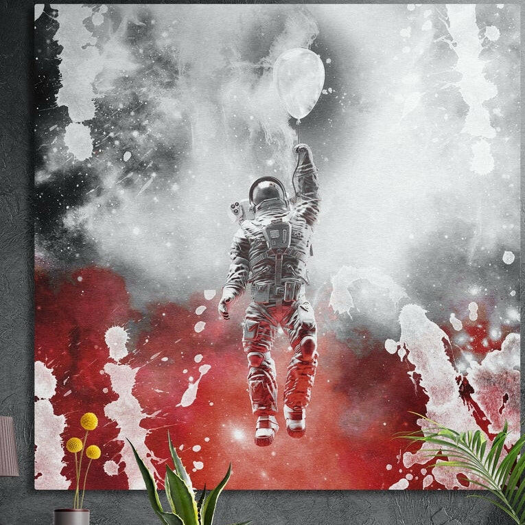 Astronaut floating upward holding a white balloon through white smoke over bold red paint splashes, brushed aluminum wall art