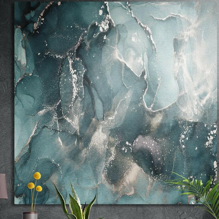 Teal, slate and silver marble with fine white veins, brushed aluminum wall art on a dark wall behind plants