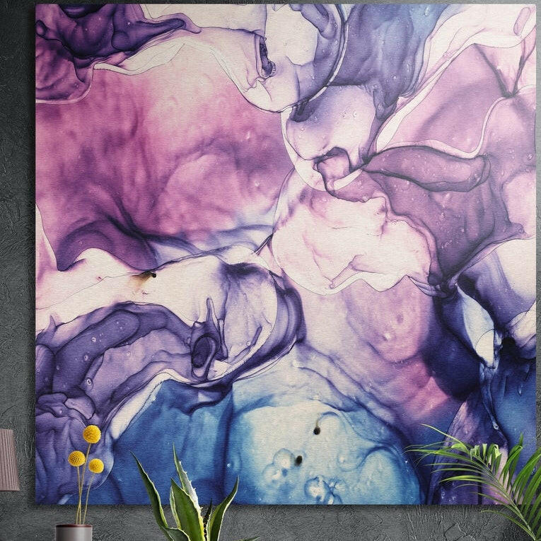 Violet and cobalt ink swirls with pink highlights, brushed aluminum wall art on a dark wall with plants in front