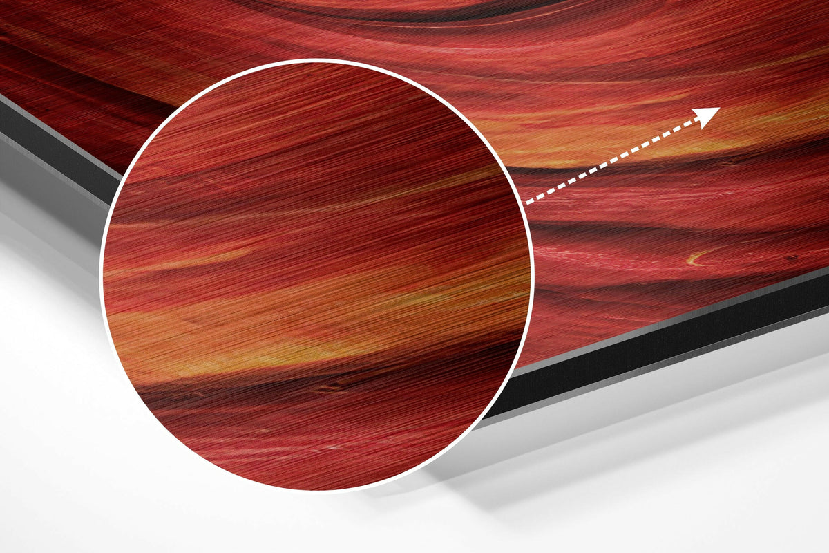 Magnified detail of the brushed metal grain showing through the red spiral swirl abstract print