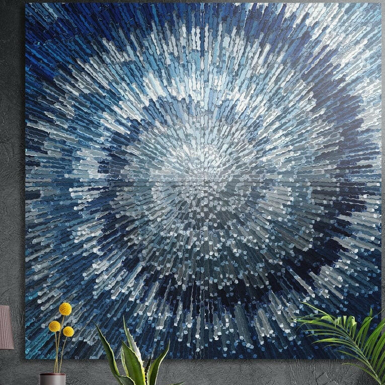 Icy blue and silver shards bursting from a bright center, brushed aluminum wall art behind plants