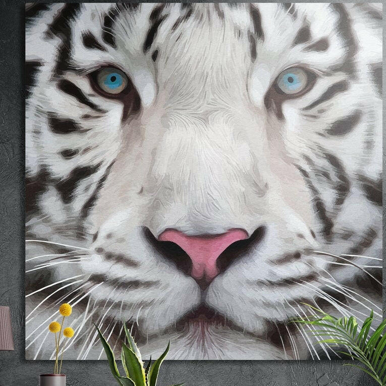 Close view of a white tiger face with ice blue eyes, brushed aluminum wall art on a dark wall behind plants