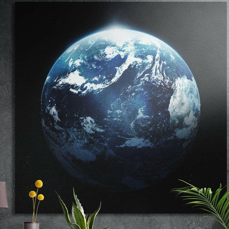 Planet Earth with blue oceans and white clouds floating in black space, brushed aluminum wall art above potted plants