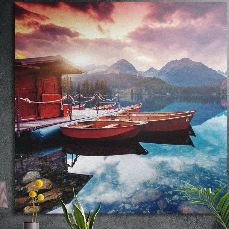 Red rowboats moored by a wooden dock and red boathouse on a clear mountain lake at sunset, brushed aluminum wall art