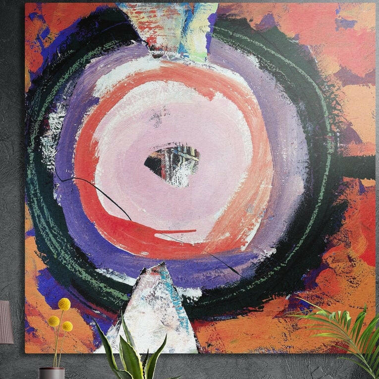 Brushy rings of pink, red, violet and green on an orange ground, brushed aluminum wall art behind plants