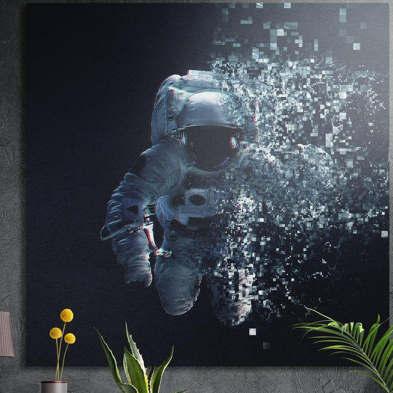 Astronaut in a white spacesuit breaking apart into floating pixel squares against dark space, brushed aluminum wall art