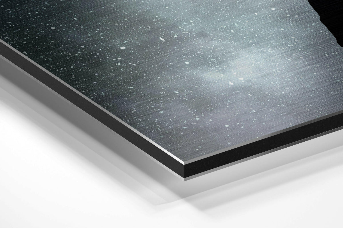 Man lifted by balloons across the moon brushed aluminum panel corner close-up showing the brushed metal grain