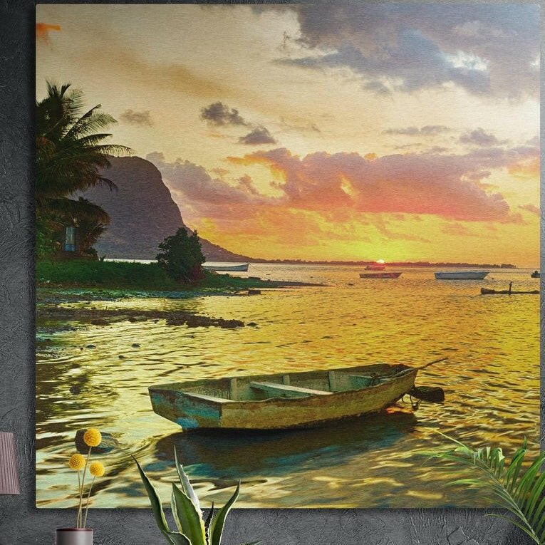Rowboat on a golden lagoon at sunset, palms behind, brushed aluminum wall art on a dark wall behind plants