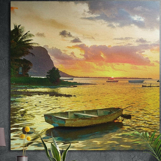 Rowboat on a golden lagoon at sunset, palms behind, brushed aluminum wall art on a dark wall behind plants