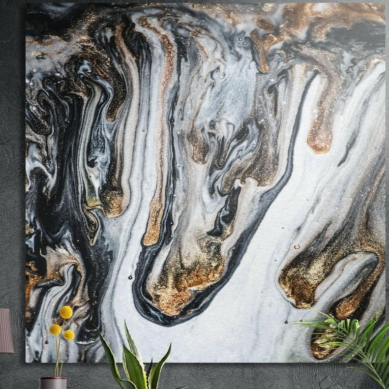 Flowing swirls of black, white and gold in a marble pattern, brushed aluminum wall art above potted plants and yellow flowers