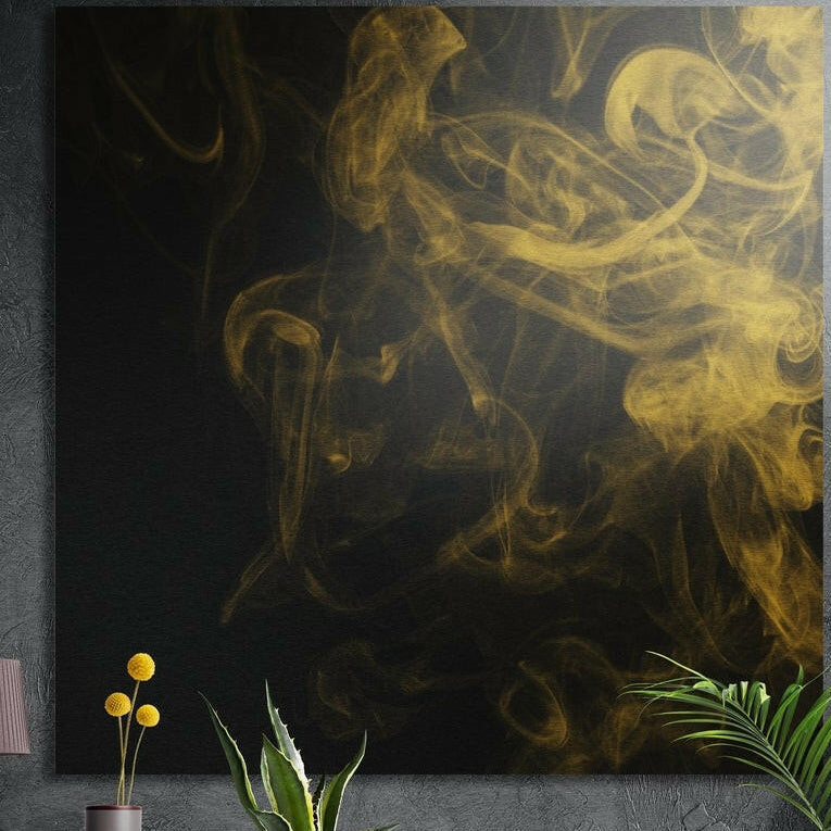 Golden smoke wisps curling over a black background, brushed aluminum wall art on a dark wall with plants in front