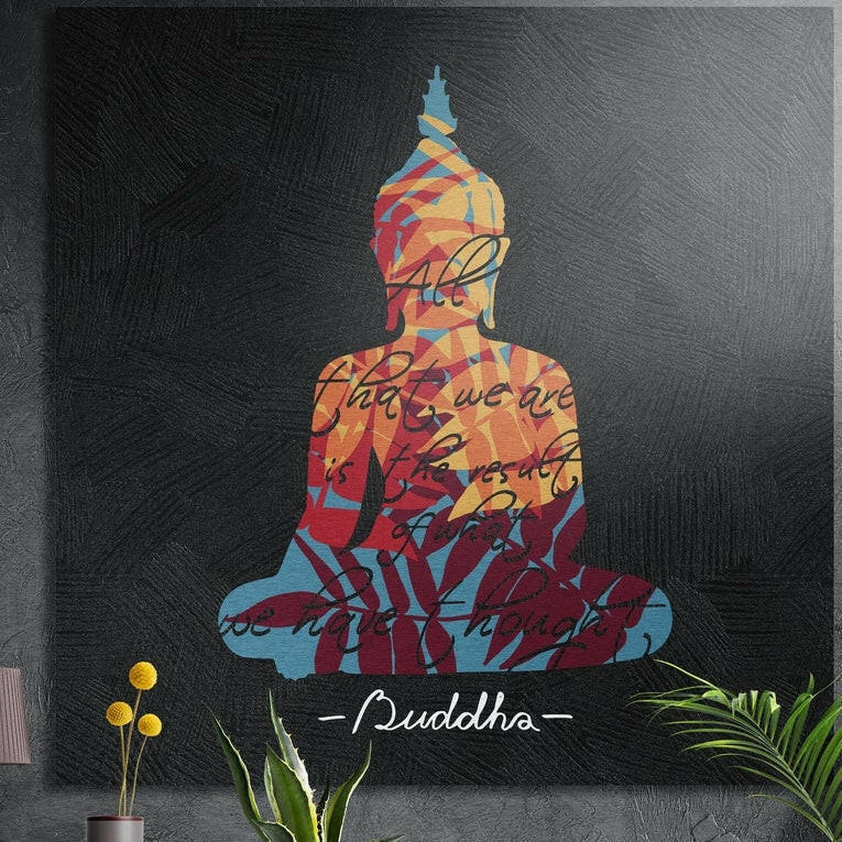 Seated Buddha silhouette filled with colorful leaf patterns on black, brushed aluminum wall art behind plants