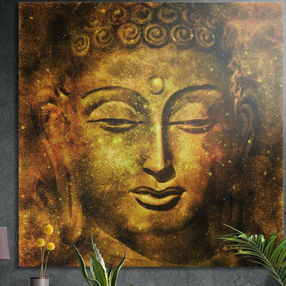 Golden Buddha face with curled hair and half-closed eyes, brushed aluminum wall art above potted plants