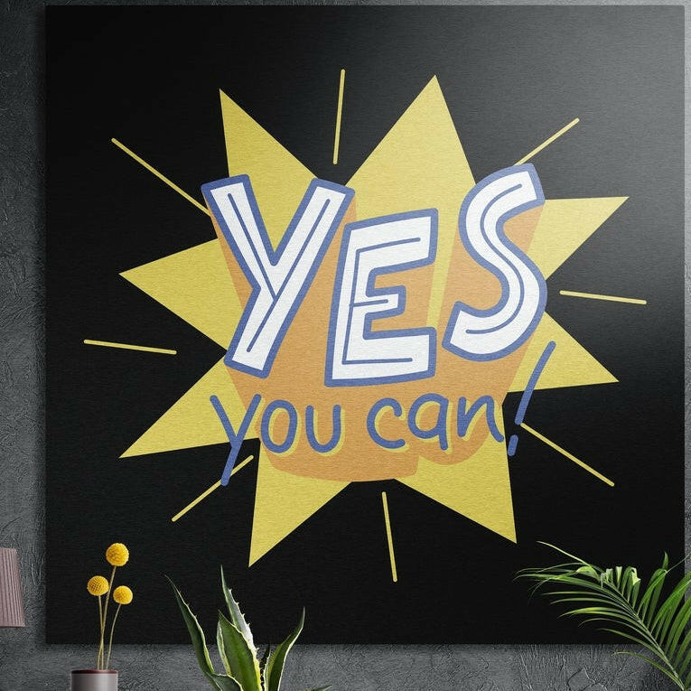 Yes you can lettering on a yellow and orange star burst, brushed aluminum wall art on a dark wall behind plants