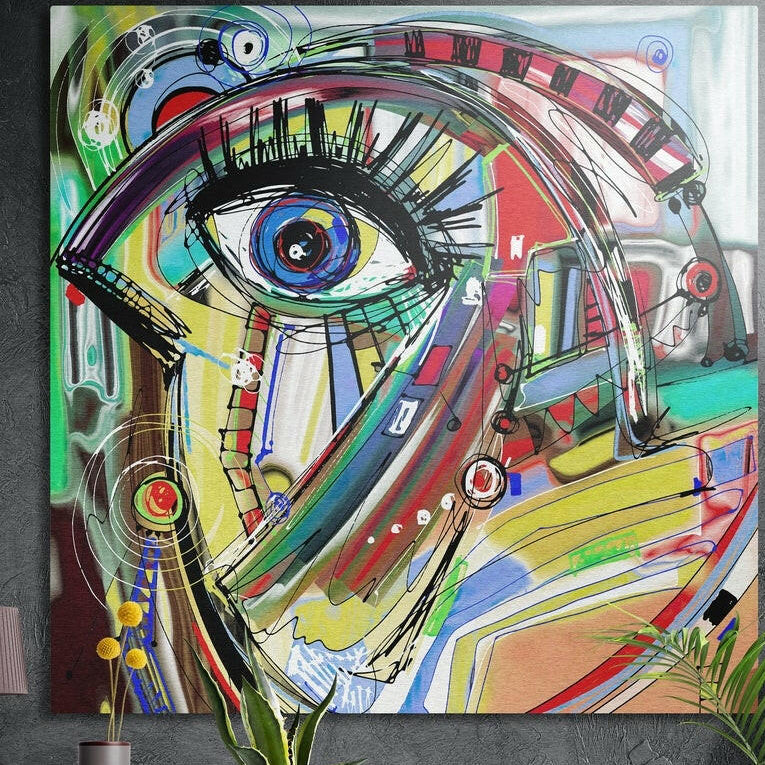 Colorful abstract doodle of a blue eye with ink scribbles, brushed aluminum wall art on a concrete wall behind plants