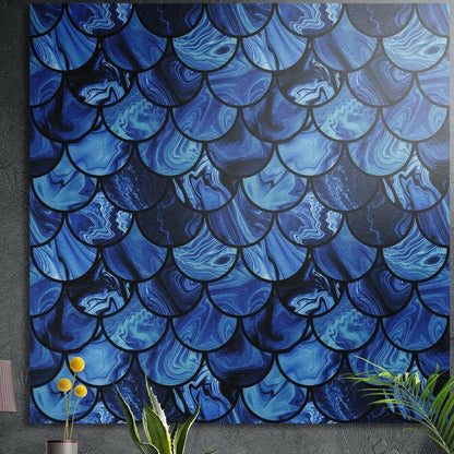 Rows of overlapping blue scale shapes with marbled swirls inside, brushed aluminum wall art above potted plants