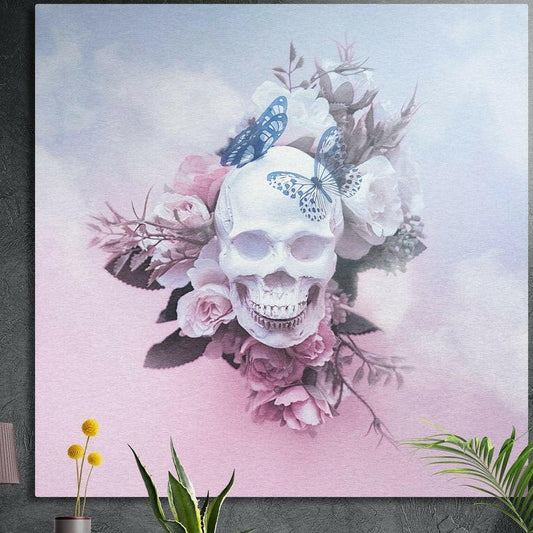 Cloudy sky rose and butterfly skull brushed aluminum wall art on a dark concrete wall behind potted plants