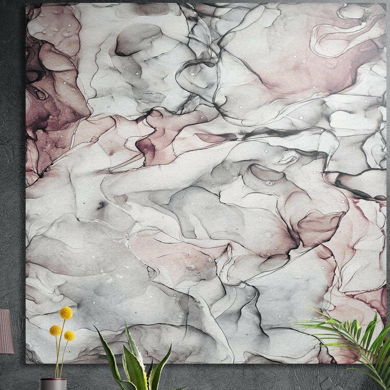 White and pink veined marble brushed aluminum wall art on a dark concrete wall behind potted plants