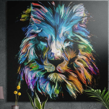 Rainbow brushstroke lion head on black, square brushed aluminum wall art on a gray wall behind plant leaves