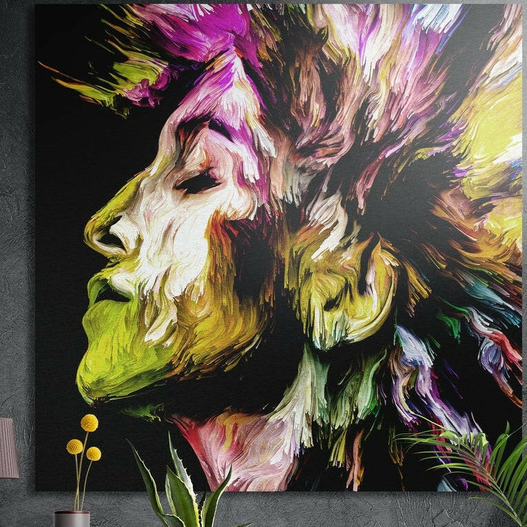 Yellow and magenta brushstroke profile brushed aluminum wall art on a dark concrete wall above yellow flowers and plants