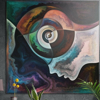 Spiral eye between two face profiles in teal, copper and violet, brushed aluminum wall art on a concrete wall behind plants