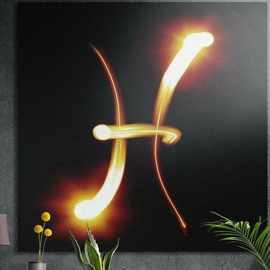 Pisces zodiac sign in fiery gold light brushed aluminum wall art on a gray concrete wall above plants