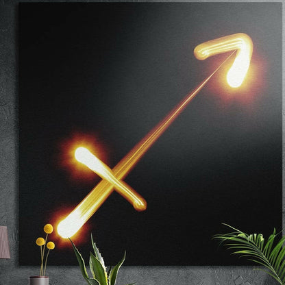Sagittarius zodiac sign in gold light brushed aluminum wall art on a gray concrete wall above plants