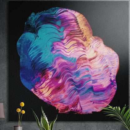 Pink and teal ripple abstract brushed aluminum wall art on a dark concrete wall above potted plants and yellow flowers