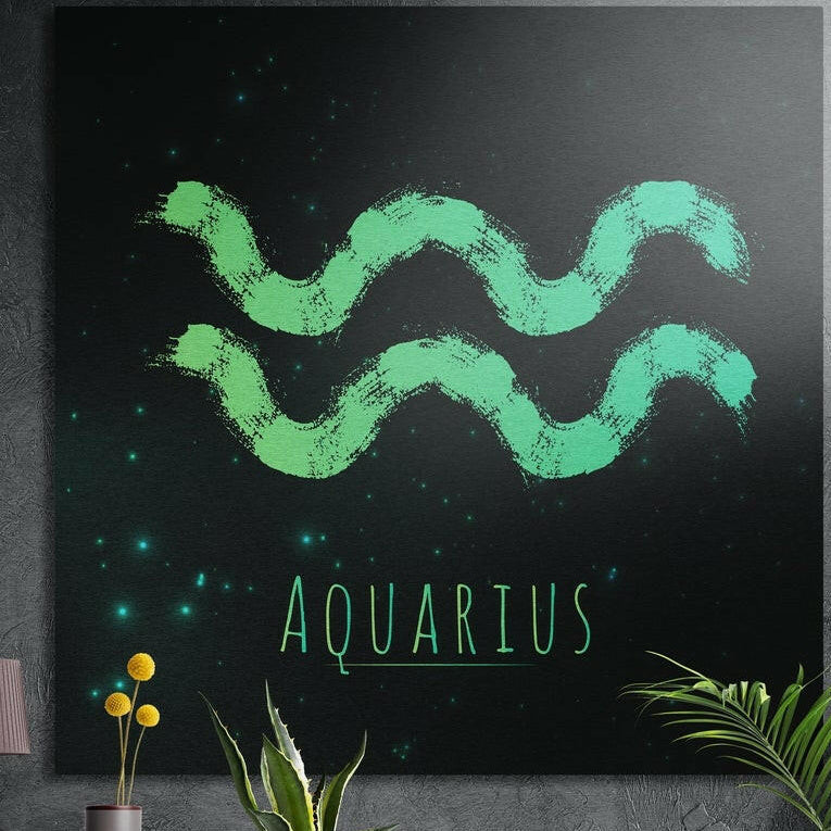 Aquarius zodiac sign in green brushstrokes brushed aluminum wall art on a gray concrete wall above plants