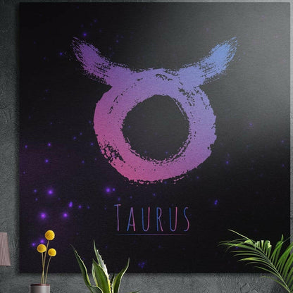 Taurus zodiac sign in pink purple brushstrokes brushed aluminum wall art on a gray concrete wall above plants