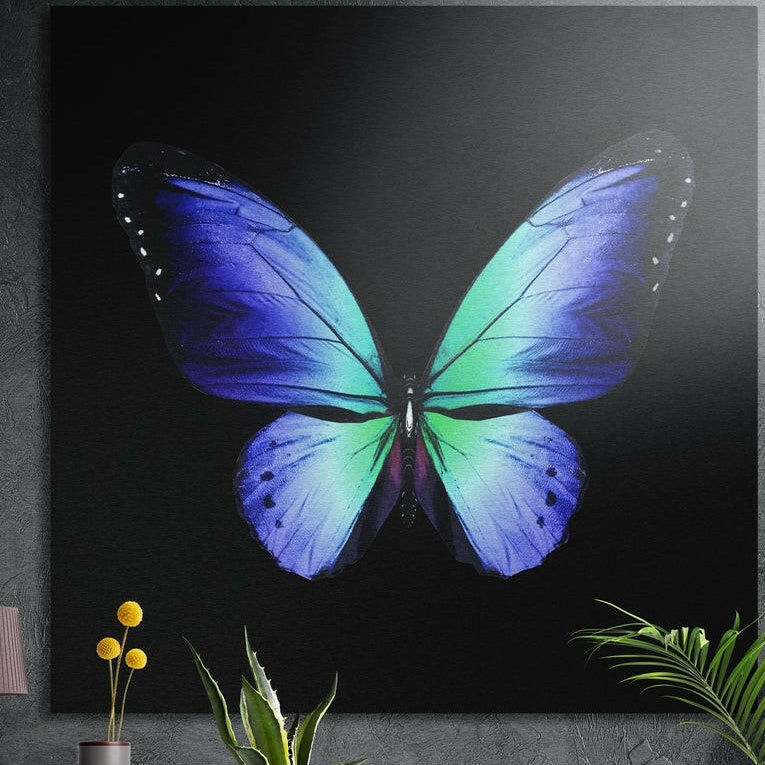 Blue and green butterfly on a black background, brushed aluminum wall art on a gray wall above yellow flowers