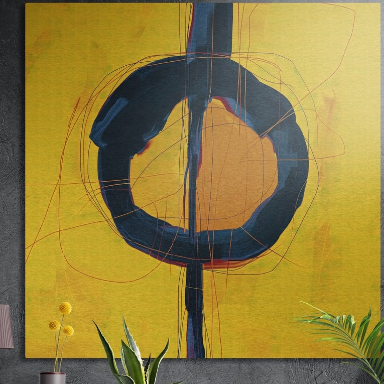Mustard yellow and navy circle abstract brushed aluminum wall art on a gray wall above yellow flowers and plants