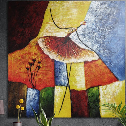 Ballerina in a brick-red tutu over red, gold, blue and green color blocks, square brushed aluminum wall art on a dark wall