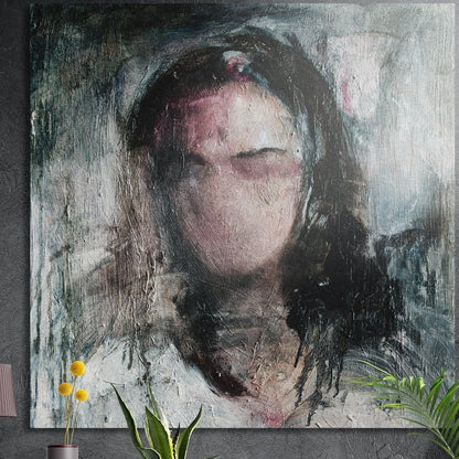 Expressive portrait of a woman with closed eyes, brushed aluminum wall art on a dark concrete wall above yellow flowers