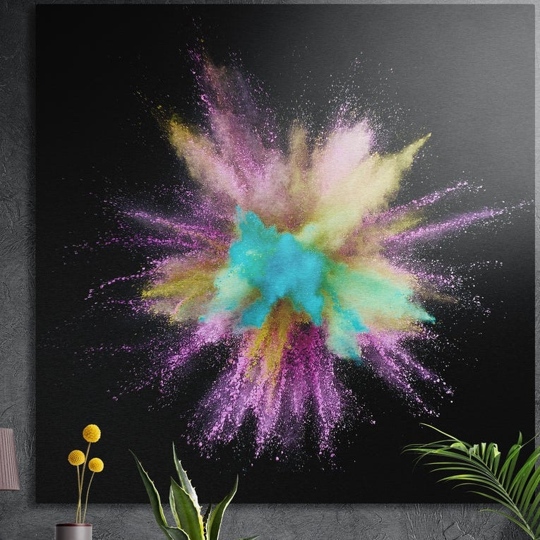 Turquoise and pink powder explosion brushed aluminum wall art on a dark concrete wall behind potted plants