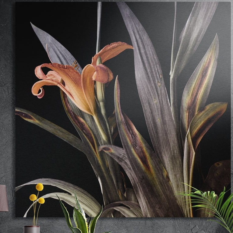 Dark orange lily brushed aluminum wall art with gray leaves on black, on a dark gray wall behind potted plants