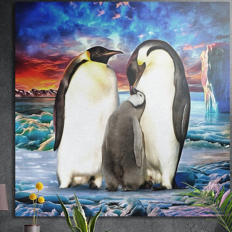 Emperor penguin family on ice under a sunset sky, square brushed aluminum wall art on a gray wall behind plant leaves