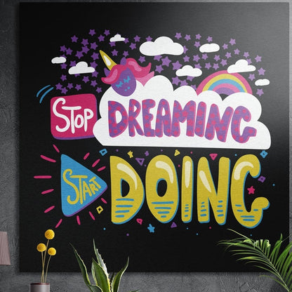 Stop Dreaming Start Doing typography brushed aluminum wall art on a dark textured wall behind yellow flowers and plants