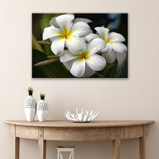 White frangipani flowers with yellow centers and green leaves canvas wall art