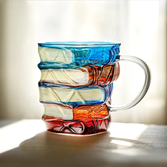 Artistic borosilicate book mug in natural light showing multicolor book-stack texture