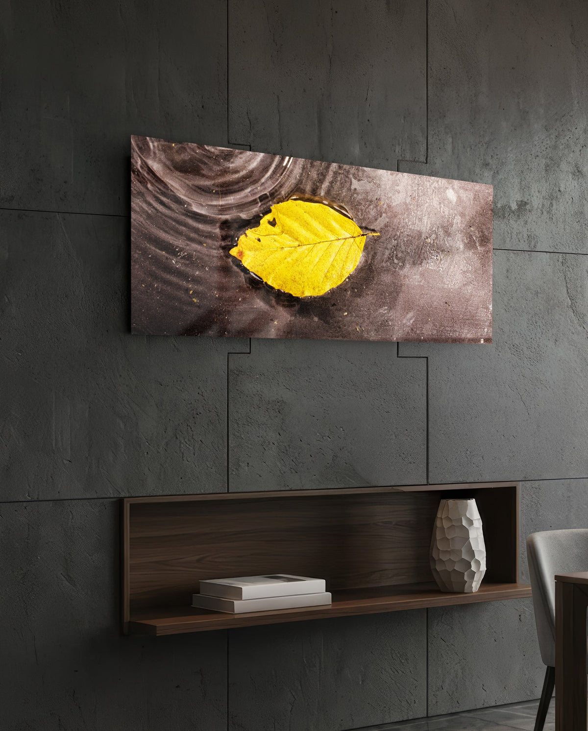 Yellow leaf on rippled water glass wall art on a dark slate wall above a walnut floating shelf