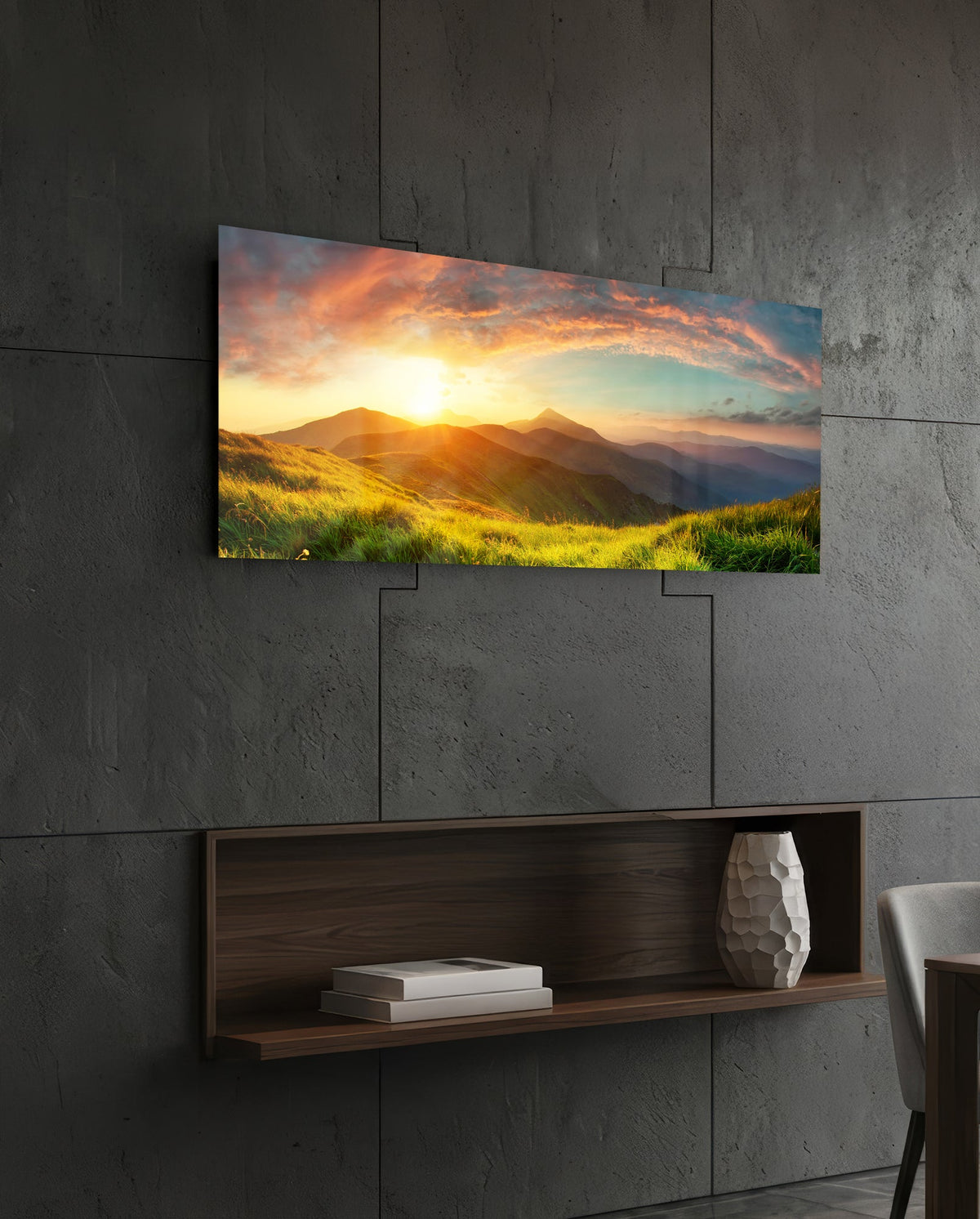 Golden sunset green hills panoramic glass wall art above a floating wood shelf on a dark stone wall