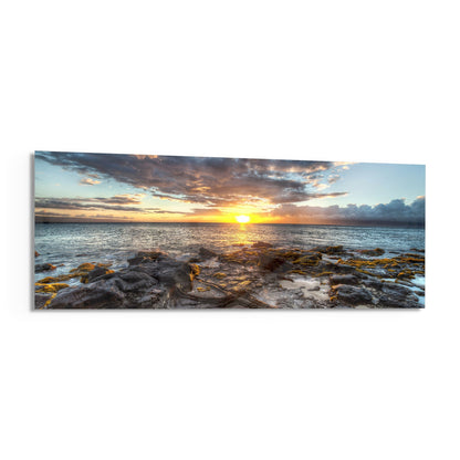 Rocky shore ocean sunset panoramic glass wall art angled on a white background