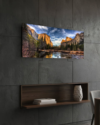 Granite cliffs river valley panoramic glass wall art above a floating wood shelf on a dark stone wall