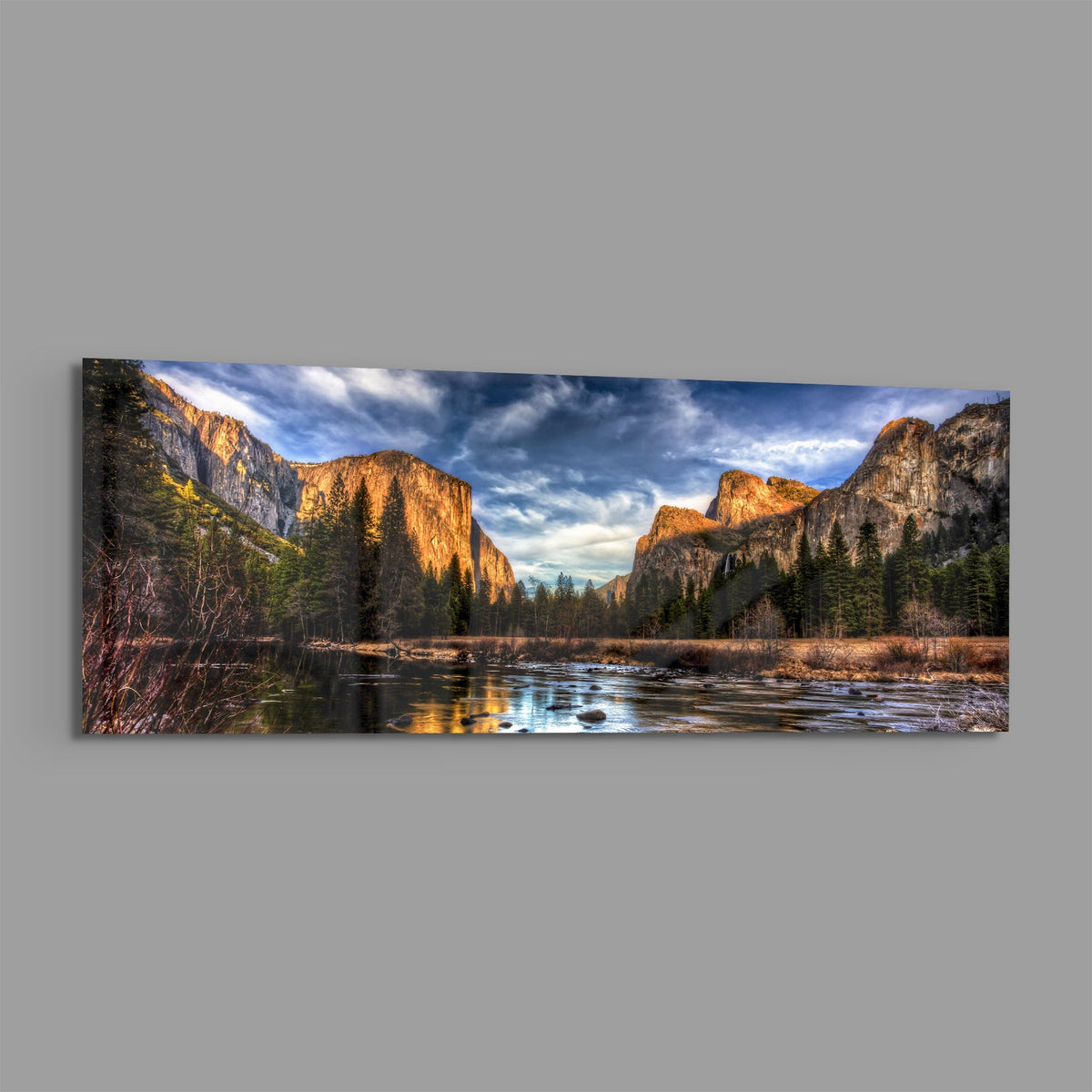 Granite cliffs river valley panoramic glass wall art on a plain gray wall
