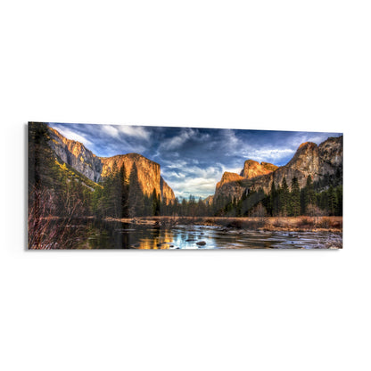 Granite cliffs river valley panoramic glass wall art angled on a white background